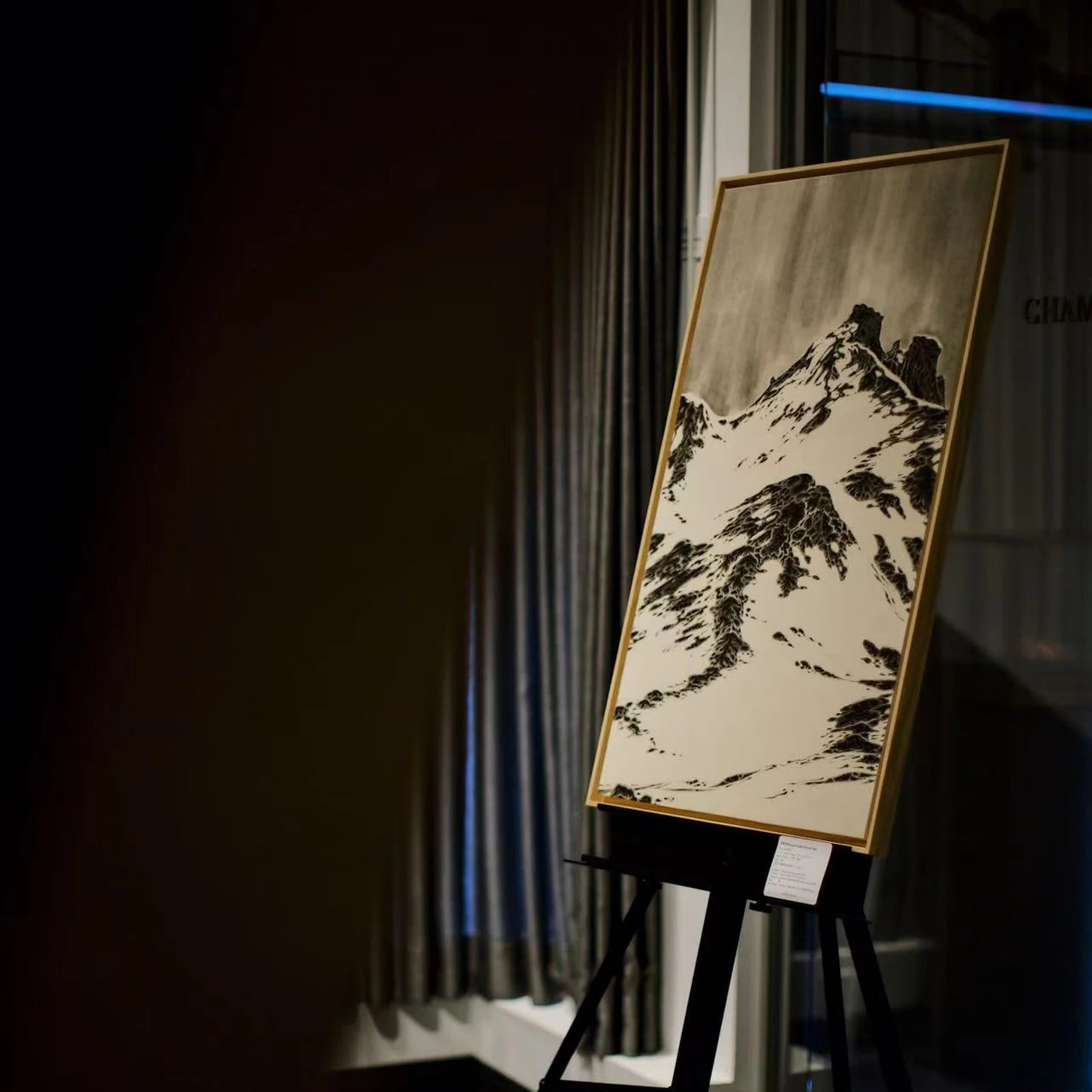Chinese landscape artwork displayed on an easel